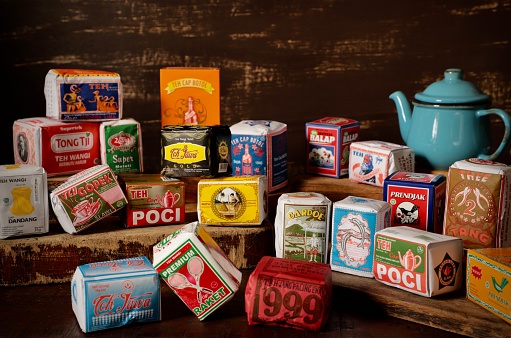 Jakarta, Indonesia - August 12, 2020: Assorted loose teas from various local brands in Indonesia. The teas are placed on display and arranged on rustic wooden blocks. The arrangement are made based on colours, packaging orientations and sizes. Most of the teas come from companies located in Java.