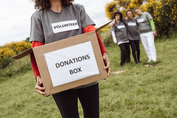 istock volunteer holding the donation box 1266071234