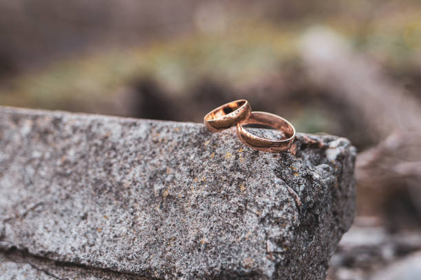 istock Gold rings on gray stones. Wedding day. 1266075144