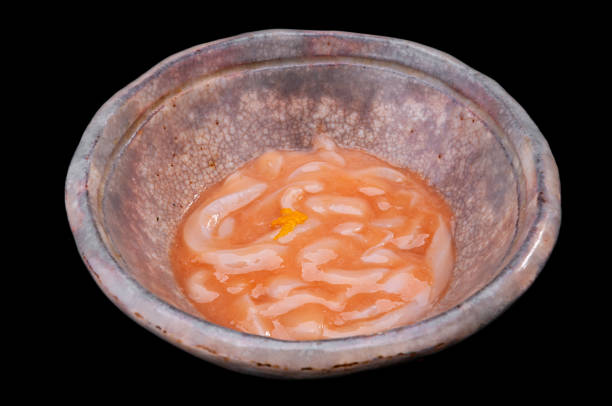 Japanese squid pickled with salt or Ika shiokara with black background.