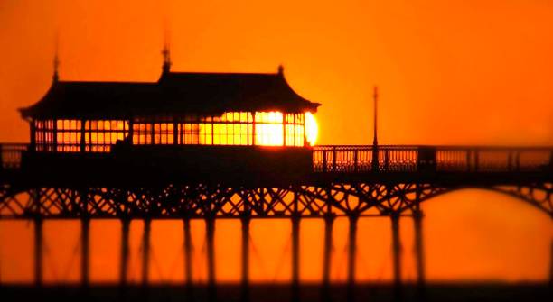 Pier at St Anne’s, Lancashire Long lens shot of pier at sunset lytham st. annes stock pictures, royalty-free photos & images