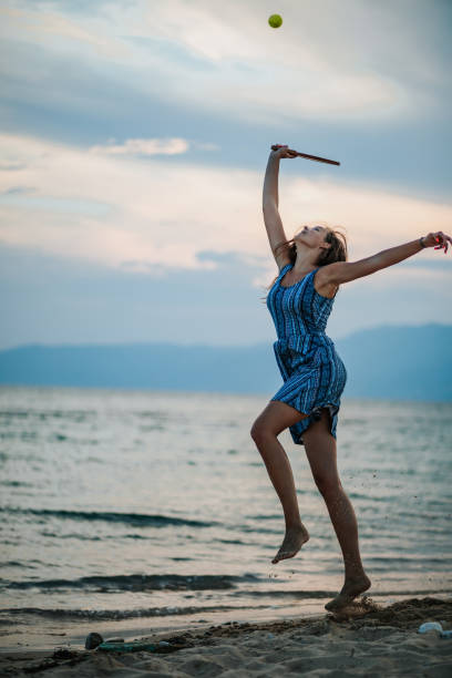 istock Young woman playing paddle ball at the beach 1266078602