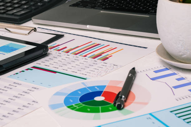 istock The analyst's desktop. Tables with numbers, computer and tablet. Concept of accounting and education 1266087954