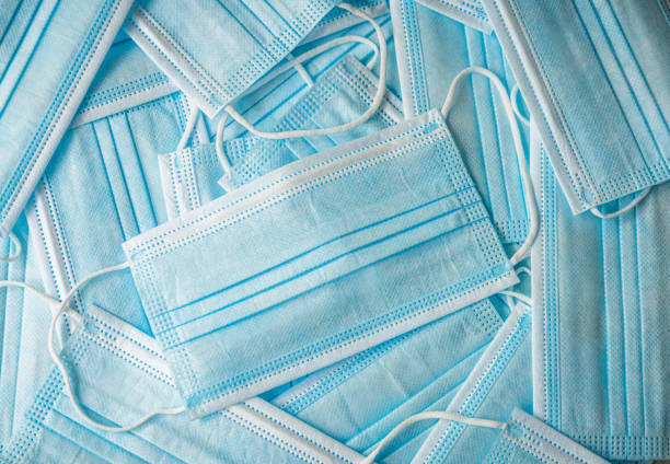 New face masks Close-up of a collection of disposable, single-use face masks. protective-face-mask stock pictures, royalty-free photos & images