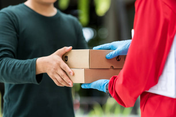 istock Delivery man is sending goods to customers. 1266091944