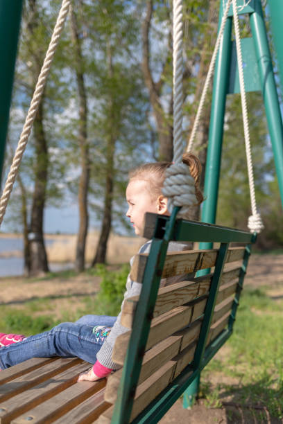 istock Child swinging a swing. child sitting on a swing 1266092285