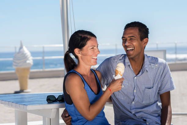 istock Playful couple eating ice cream 1266093018