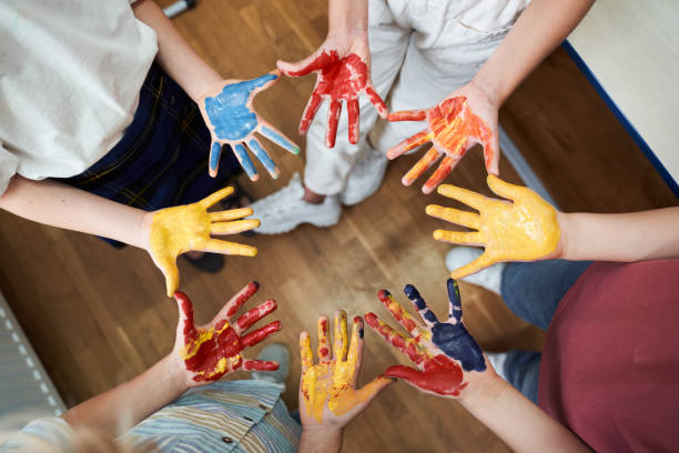 Happy kids with dirty palms after art lesson