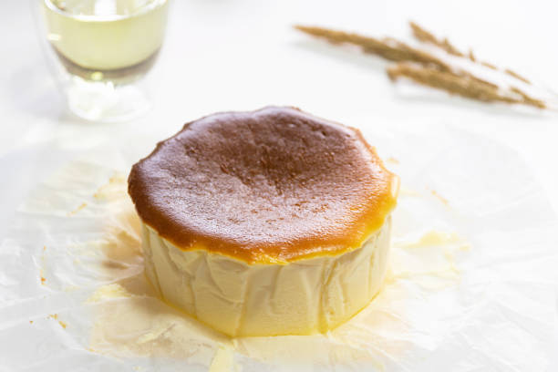 istock Pound of Basque Burnt Cheesecake on white baking paper. 1266095082