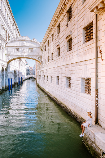 Beautiful venetian street in summer day, Italy. Venice Europe woman on city trip in Venice