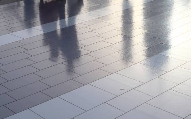 istock Diffuse reflections of pedestrians walking a marble sidewalk in dubai 1266096632