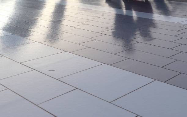 istock Diffuse reflections of pedestrians walking a marble sidewalk in dubai 1266096713