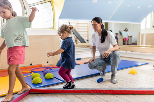istock Physical therapist working with kids 1266097967