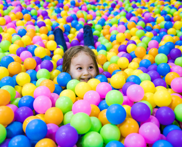 istock Child plays in the pool with balls. One head sticks out 1266099734
