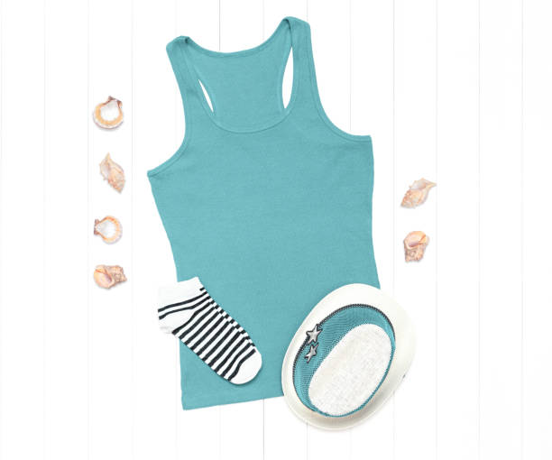 istock Mint tank top with seashells and a straw hat on a white background 1266099895