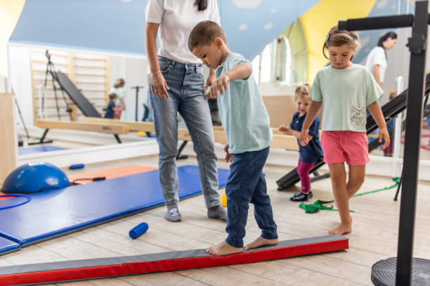 istock Physical therapist working with kids 1266103112