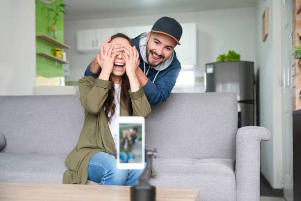 istock Influencer recording at home while her husband surprises her 1266103806