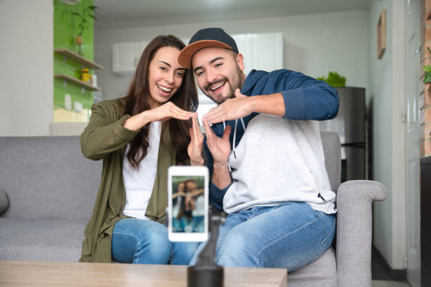 Couple at home dancing while recording content for social media