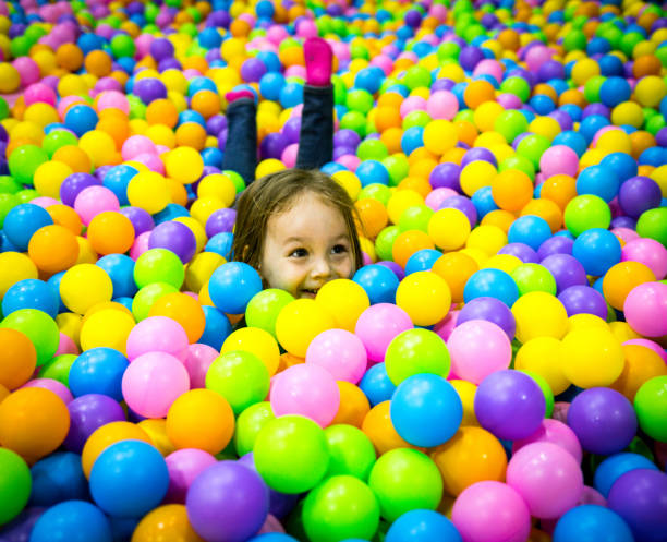 istock Child plays in the pool with balls. One head sticks out 1266104008