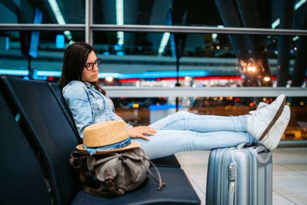 istock Woman napping at airport 1266104566