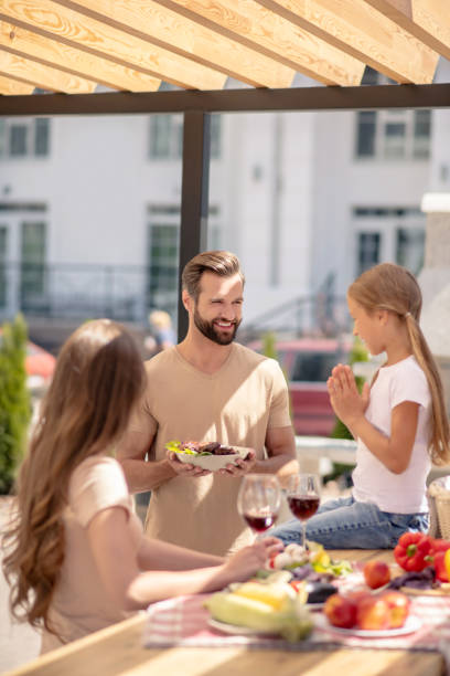 istock Dad serving the table for his cute family 1266109823