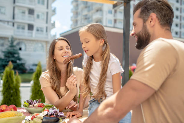 istock Young family having dinner outside and looking cheerful 1266110082