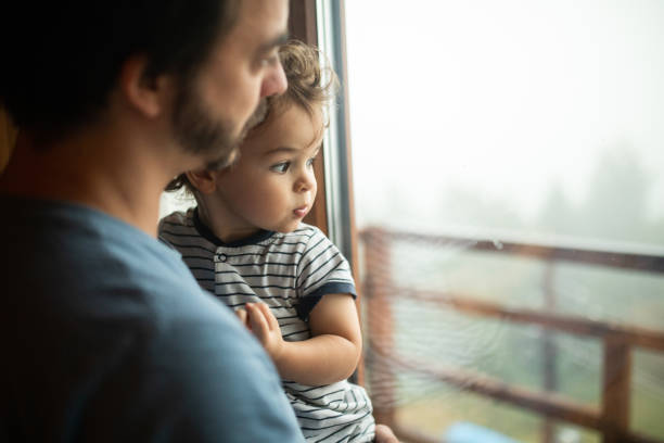 istock Cute toddler in father's arms 1266113945