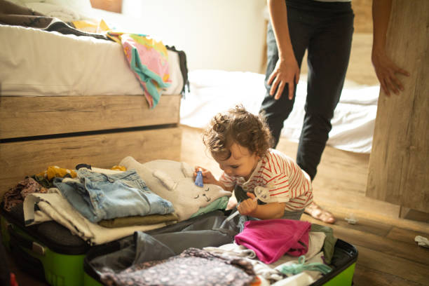 istock Little boy helping his mother to pack for vacation 1266114251