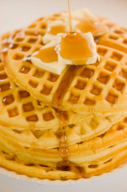 istock Waffles. Homemade Waffles  w/ crispy maple Bacon, butter & maple syrup. Classic American breakfast or brunch favorite. Made from scratch Waffles w/ bacon, butter & maple syrup. 1266114928