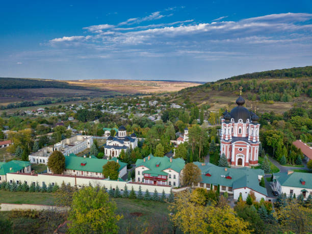 istock Flight over a christian monastery surrounded by autumn forest. Kurky monastery, Moldova republic of. 1266116471