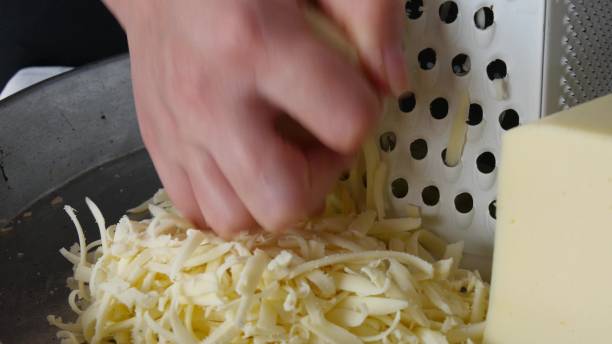 istock Chef grating cheese for pizza, close up 1266118177