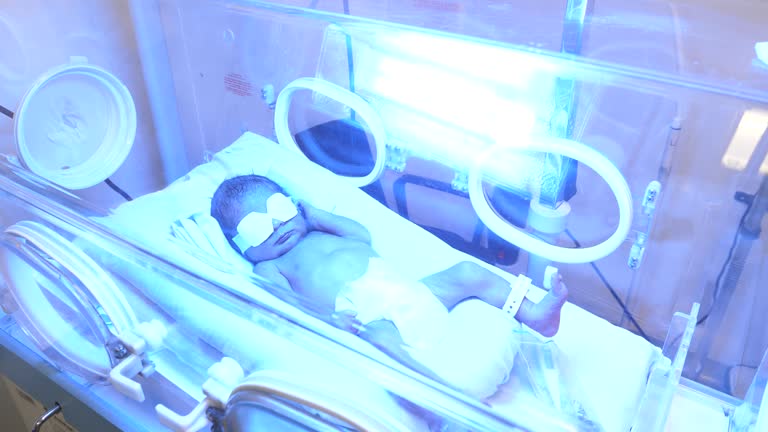 Cute little newborn in an incubator getting treated for jaundice at the NICU