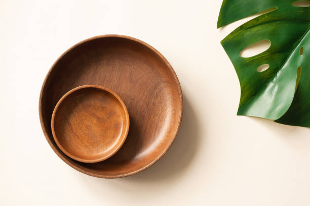 istock Wooden plates and monstera leaf flat lay composition. Empty dishes on light beige background, top view. Mockup for menu or recipe. Concept organic vegan food 1266121900
