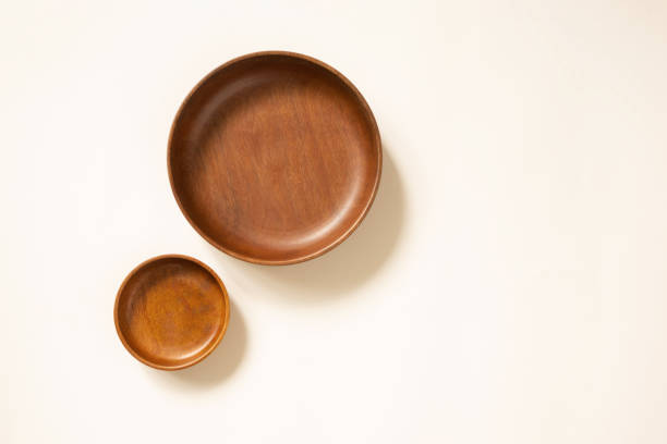 istock Empty wooden plates, top view. Craft round dishes on light beige background with copy space. Template for menu or recipe 1266121934