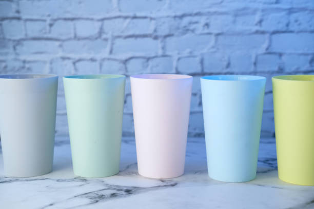 istock Plastic glass of various color on table. 1266123187