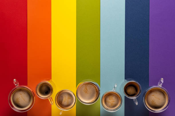 Cups with black coffee on rainbow background