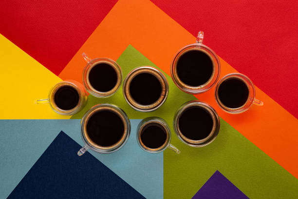 istock Few cups with black coffee on colorful background 1266123348