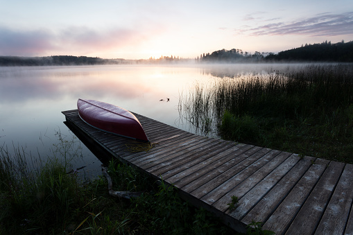 Canoe resting on a dock, evening image, Image taken from a tripod.