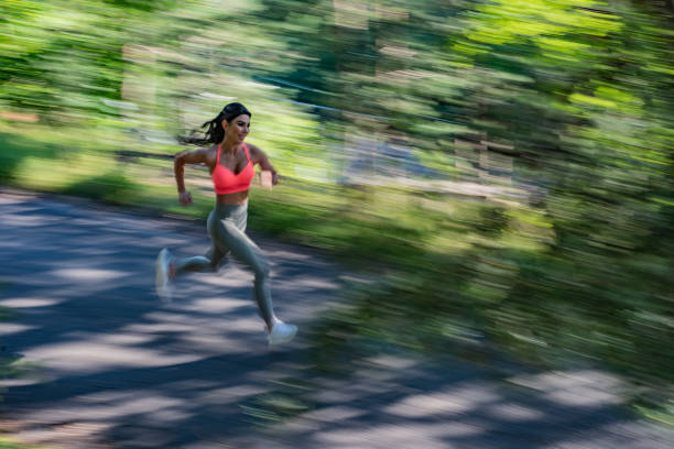istock Fit woman running at park. 1266126155
