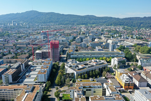 Zürich Altstetten with several residential buildings. In the background the Uetliberrg hill. The wide angle image was captured during summer season.