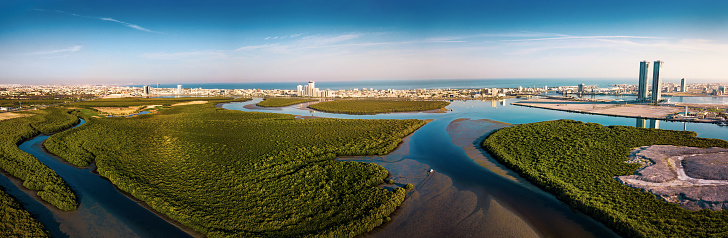 Panoramic aerial view of Ras al Khaimah over the mangroves and the creek in the United Arab Emirates at sunrise