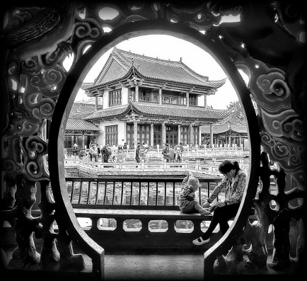 Mother and baby. Traditional architecture at Green Lake Park in Kunming city, the capital of Yunnan province, China.