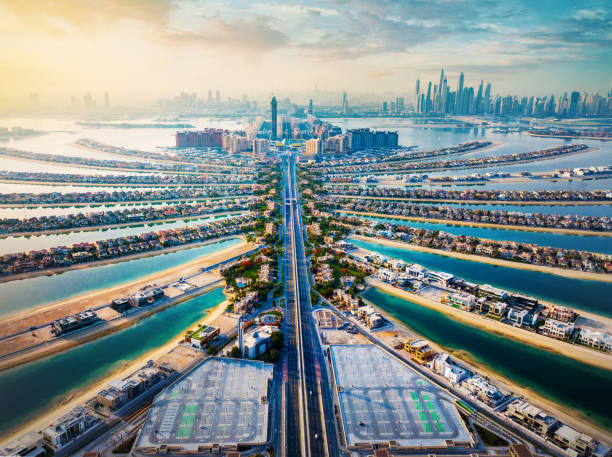 The Palm shaped island in Dubai aerial view at sunrise The Palm shaped island in Dubai United Arab Emirates aerial view at sunrise. Famous artificial island with luxury villas and hotels dubai island stock pictures, royalty-free photos & images