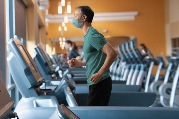 Chinese man wearing mask at the gym stock photo