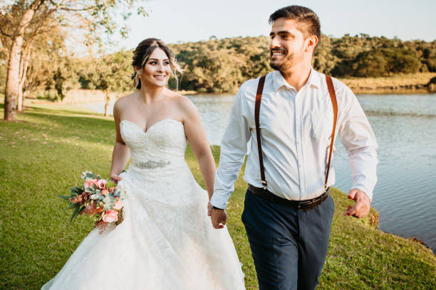 bride and groom walking together bride and groom walking together at a wedding on the farm eloping stock pictures, royalty-free photos & images