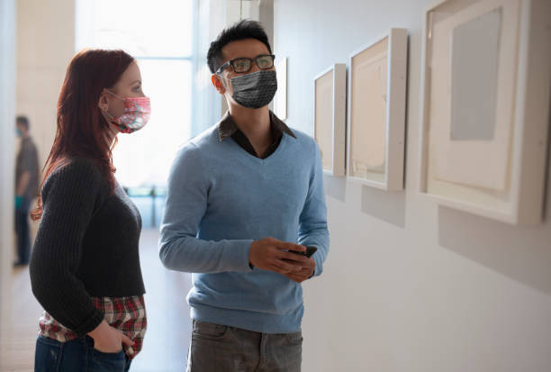 istock people social distancing at museum 1266134434