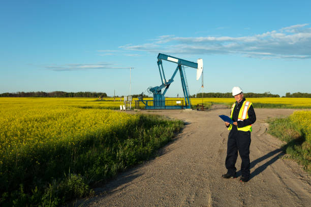 olio lavoratore sicurezza gear prairie oil - manitoba canada prairie canola foto e immagini stock