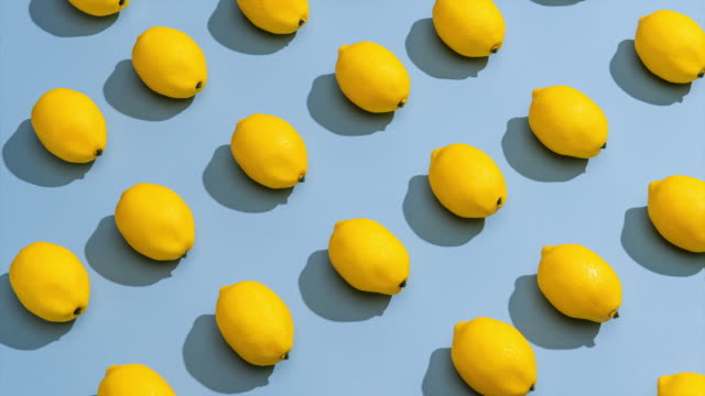 Stop Motion  of Lemons on a Blue Background.