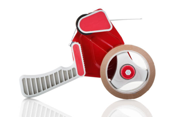 Side view of a red parcel tape dispenser on white background A side view of a red parcel tape dispenser on white background nigel pack stock pictures, royalty-free photos & images
