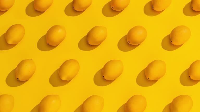 Stop Motion Collection of Lemons on a Yellow Background.